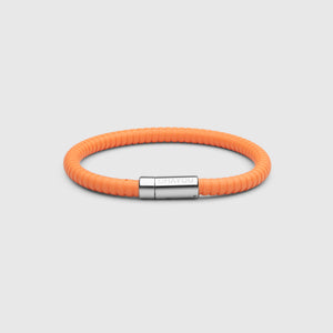 The rubber bracelet in orange with stainless steel clasp. FKM fluoroelastomer rubber – Fully waterproof. White background.