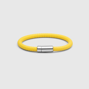 The rubber bracelet in yellow with stainless steel clasp. FKM fluoroelastomer rubber – Fully waterproof. White background.
