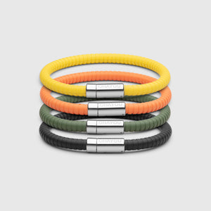 The Signature bracelet with stainless steel clasp. FKM fluoroelastomer rubber – Fully waterproof. Bundled together with in orange, yellow, green and black on white background.