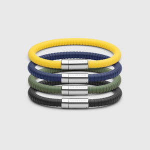 The Signature bracelet with stainless steel clasp. FKM fluoroelastomer rubber – Fully waterproof. Bundled together with in black, yellow, green and blue on white background.