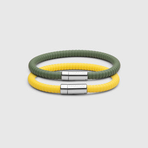 The Signature bracelet in green with stainless steel clasp. FKM fluoroelastomer rubber – Fully waterproof. Bundled together with the Signature Bracelet in yellow on white background.