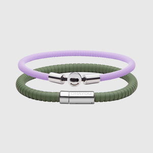 The Signature Bracelet in green with stainless steel clasp. FKM fluoroelastomer rubber – Fully waterproof. Bundled together with the Smile Bracelet in Lavender in silicon rubber, White background.