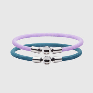  The Smile bracelet in Teal Blue Silicon Rubber with stainless steel button clasp, bundled with Smile Bracelet in Lavendar Fully waterproof. White background.