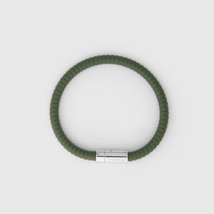 The rubber bracelet in green with stainless steel clasp. FKM fluoroelastomer rubber – Fully waterproof. White background. Seen from above.