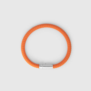 The rubber bracelet in orange with stainless steel clasp. FKM fluoroelastomer rubber – Fully waterproof. White background.